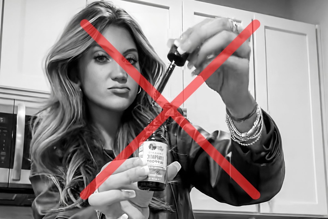 Woman holding a lymphatic drops bottle, crossed out in red — viral TikTok drops did not work